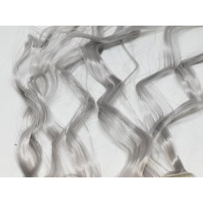 Tyndt fint paryk hr i plastik. Gr (nyt)